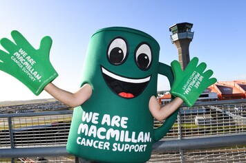 Macmillan's mascot Muggy at London Luton Airport