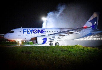 Night time water arch for inaugural FlyOne Airbus A320 at London Luton Airport